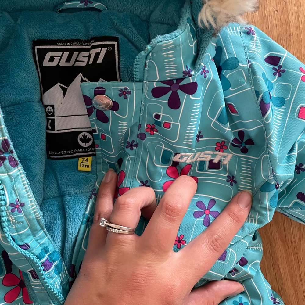 One piece Gusti Snowsuit, light blue with small flowers.